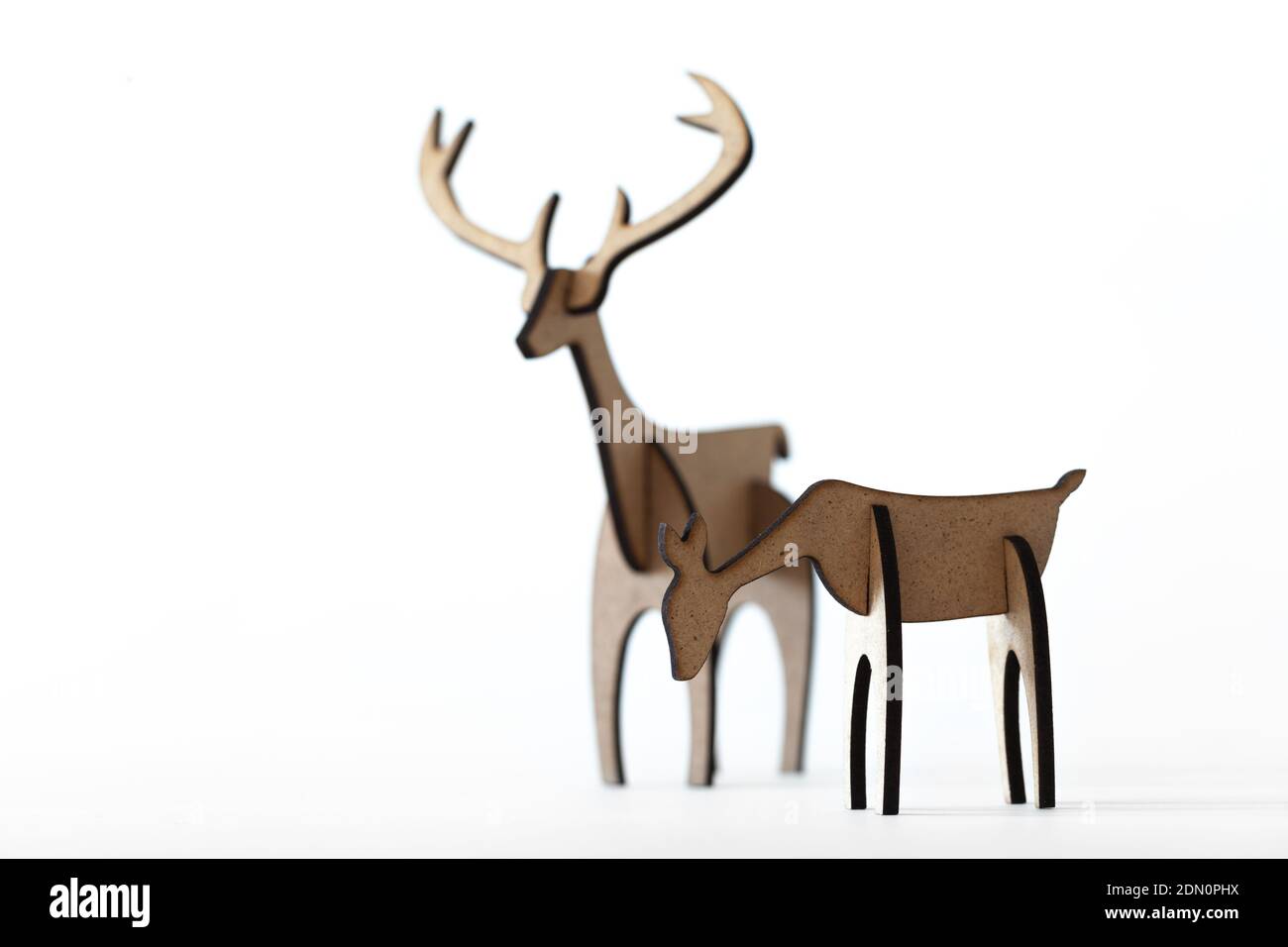 Reindeer stag and young deer cardboard toy isolated on a white background. Christmas icon and shapes with text space Stock Photo