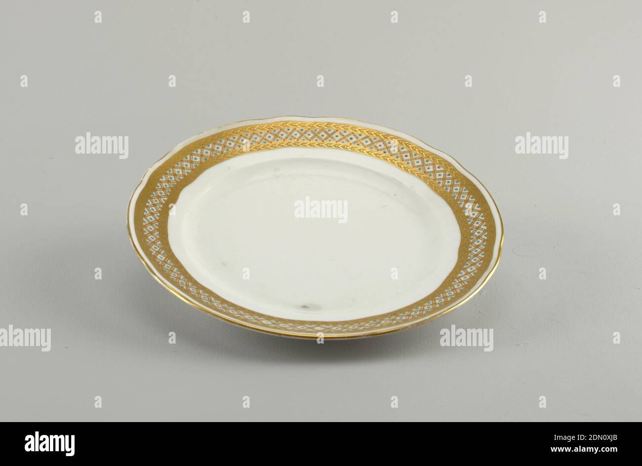 Plate, porcelain, overglaze decoration, Shaped edge with two bands of etched gold: between them, gold lattice with white and orange dots, and turquoise dots in spaces., St. Petersburg, Russia, late 19th century, ceramics, Decorative Arts, Plate Stock Photo