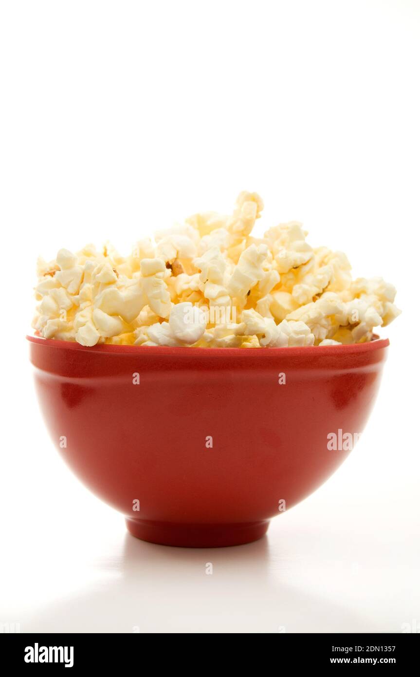 Close Front View of Buttered Popcorn in a Red Bowl Isolated on White