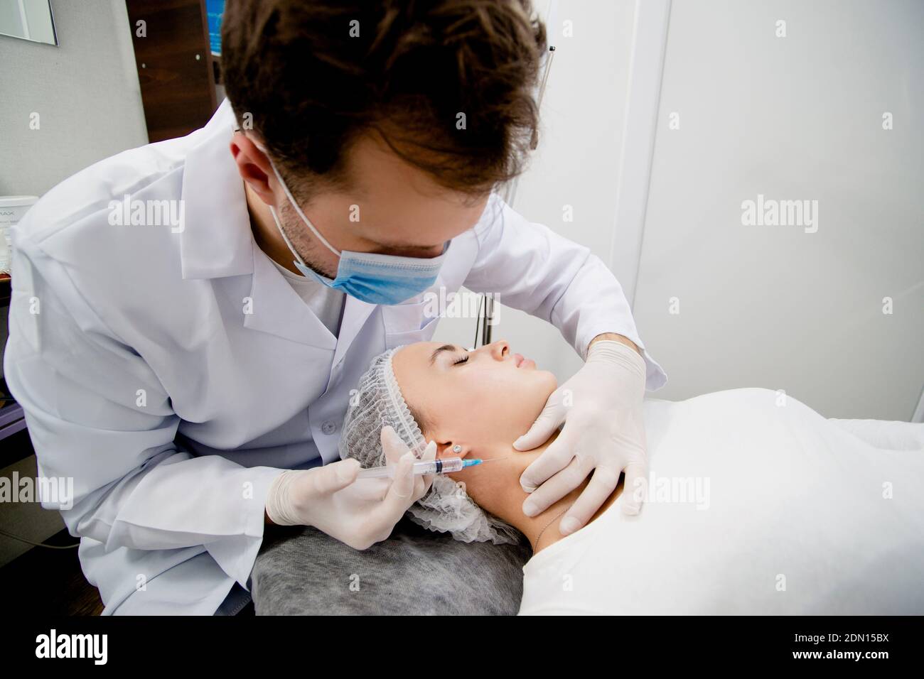 Young dermatologist is making injections to solve some age-related skin ...