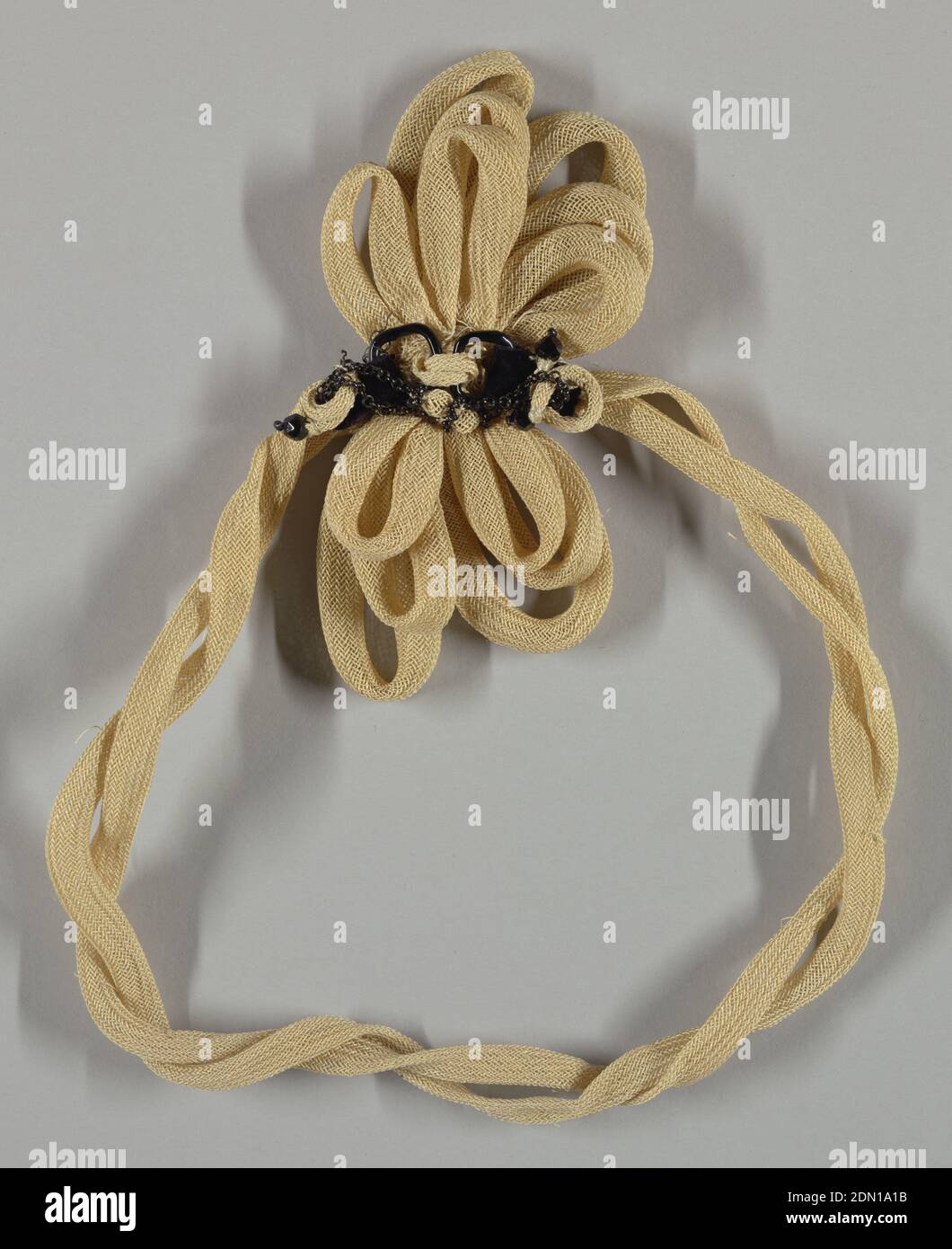 Trimming, Medium: plant fiber, metal, glass beads Technique: braided, Ornament in the form of a rosette with streamers. At the center of the rosette are two black buckles with black velvet bands, thin metal chain and black beads., France, late 19th century, trimmings, Trimming Stock Photo