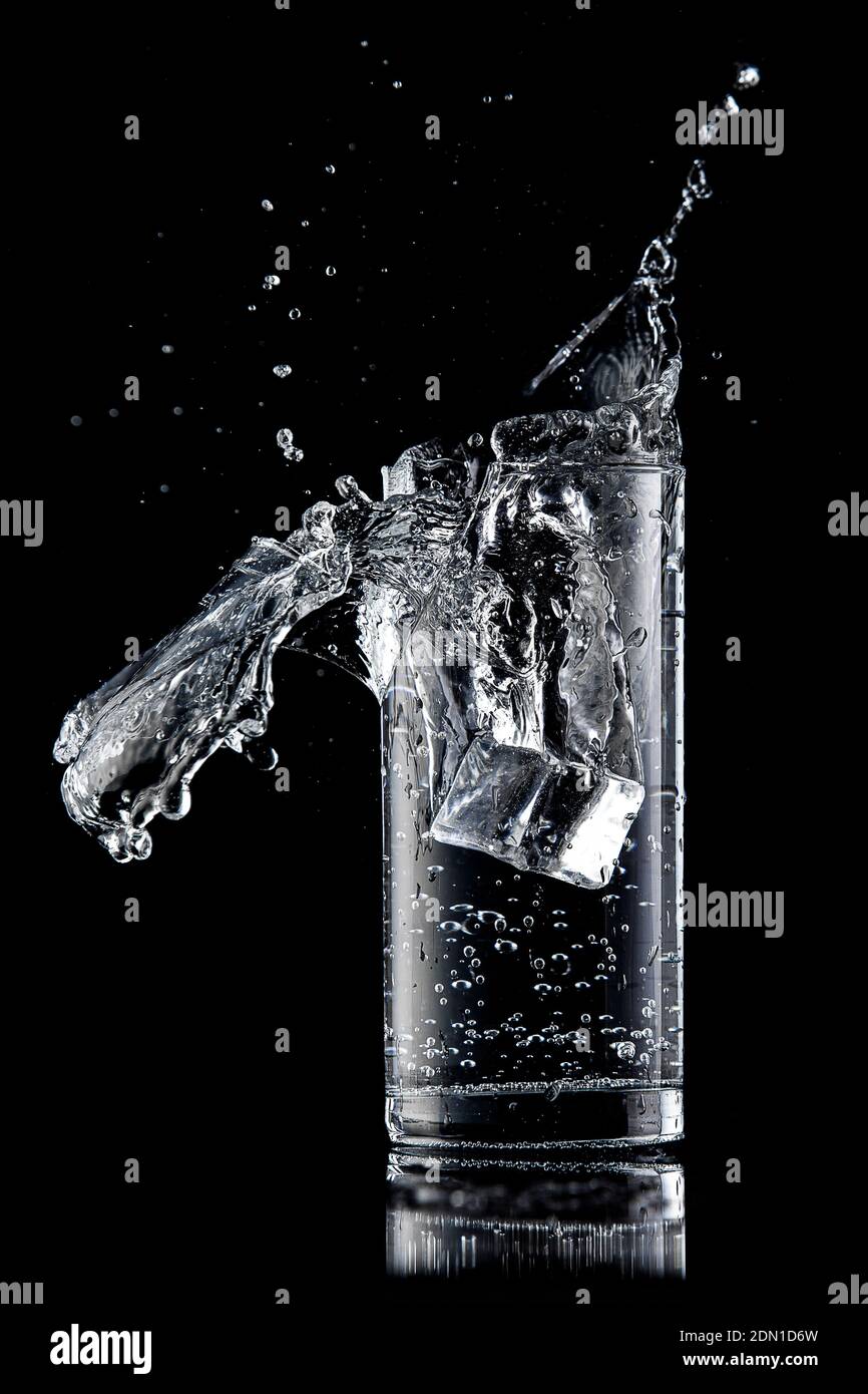 The glass of water is crashing. Water is poured out Stock Photo - Alamy