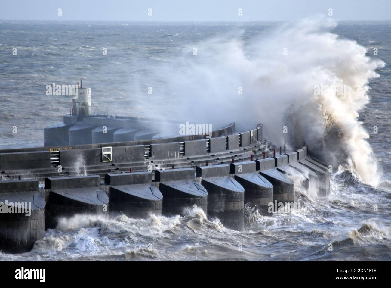 Violent wave crashing against the marina western seawall in rough sea, Brighton, Sussex, England, United Kingdom Stock Photo