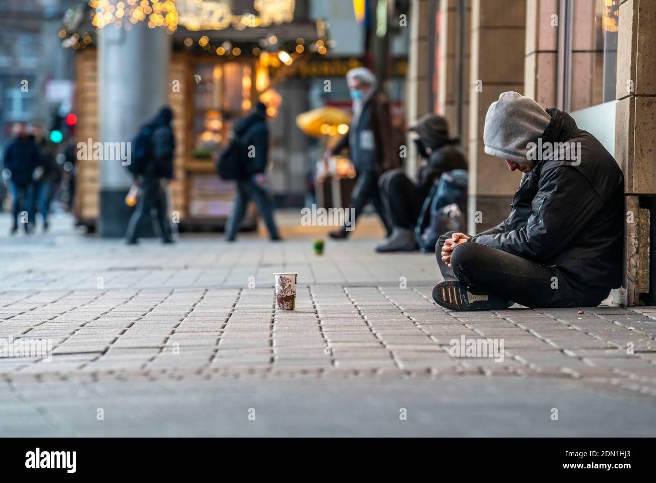 First day of the Christmas Lockdown in the Corona Crisis, homeless people on Neumarkt, closed shops, hardly any passers-by, in Cologne, NRW, Germany, Stock Photo