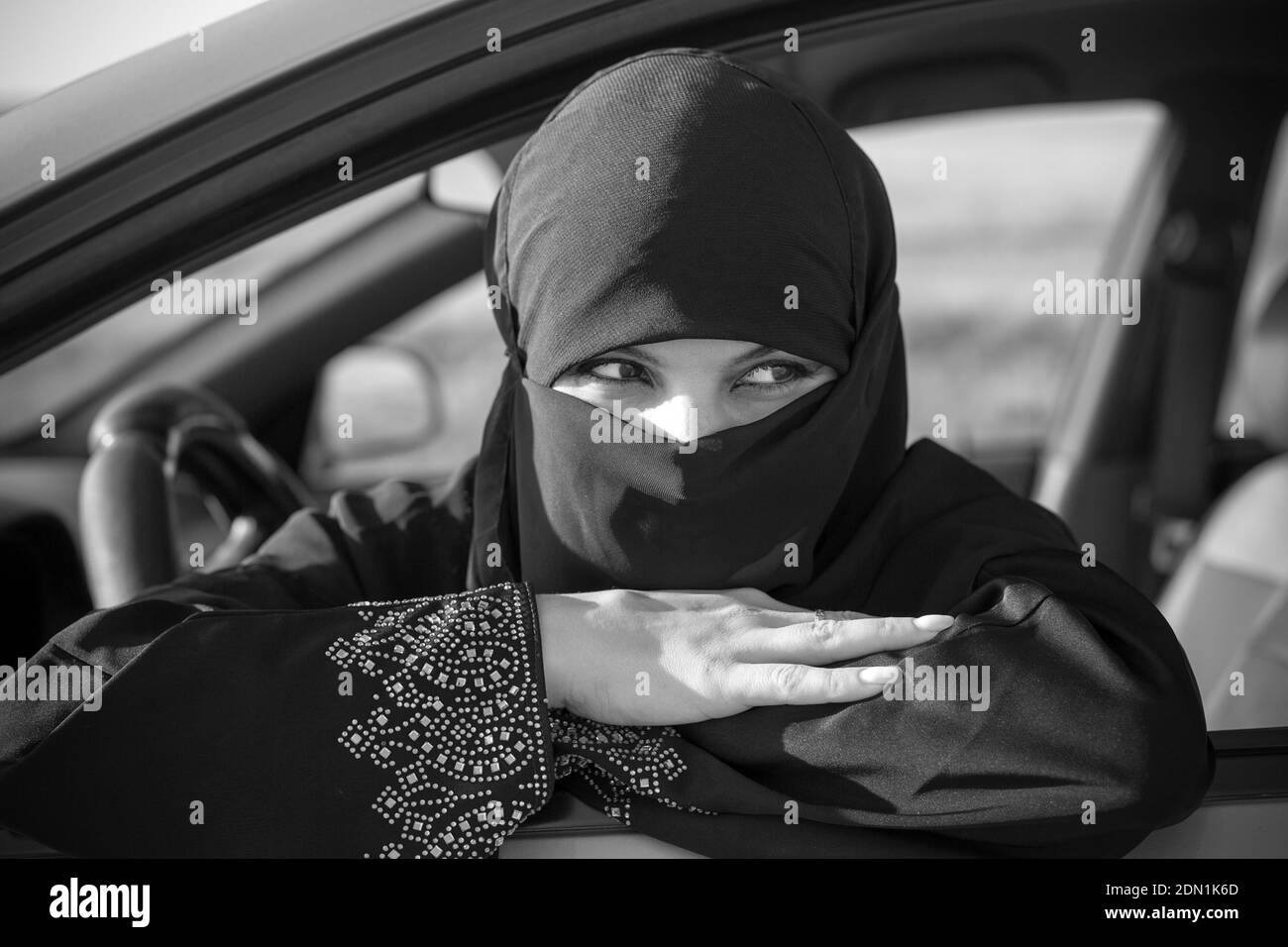 Muslim woman waiting in line in traffic jam. Black and white Stock ...