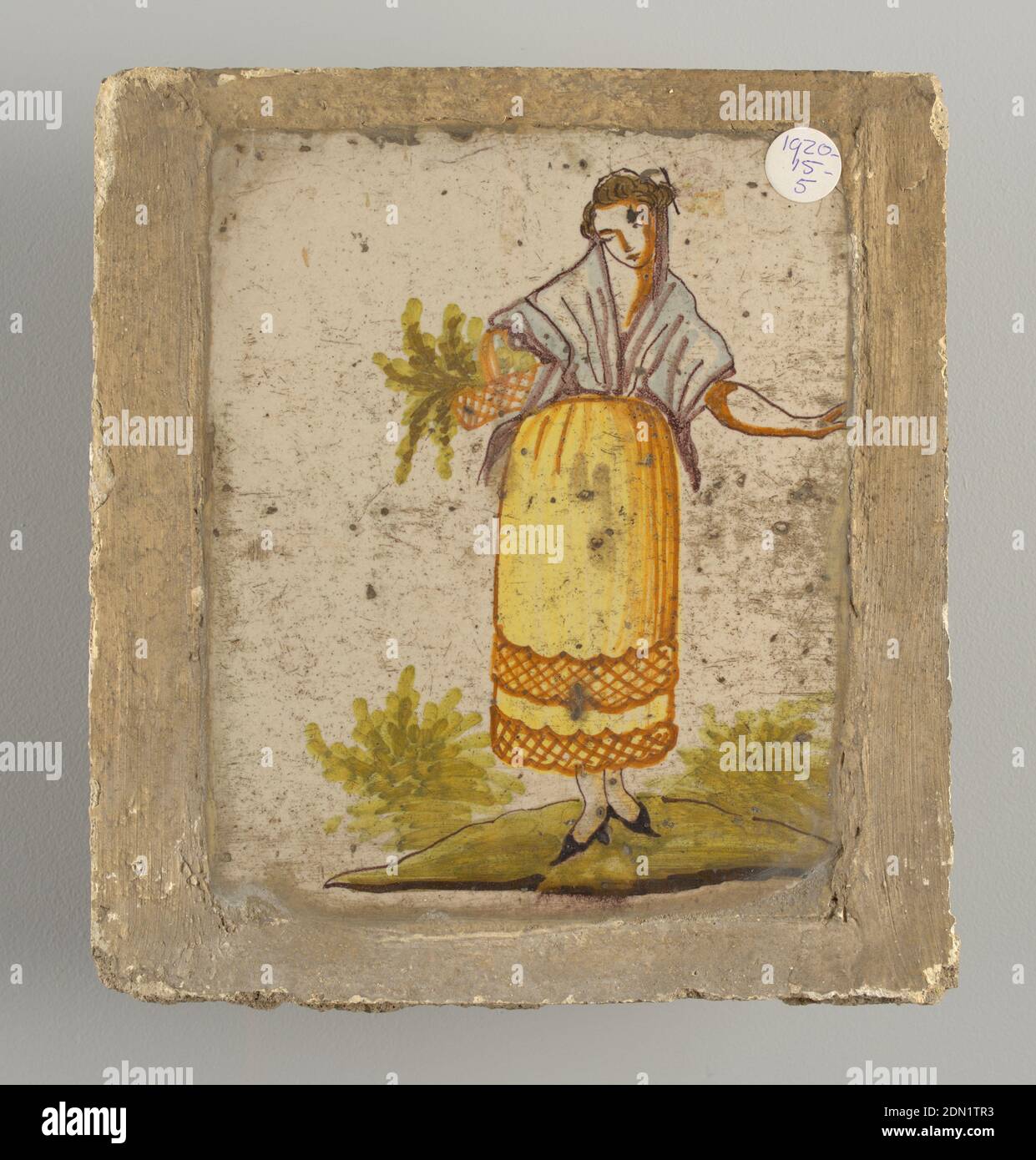 Tile, Earthenware, glazed and high fire decorated, Woman in yellow shirt and white shawl carrying a basket with greens on right arm., Alcora, Spain, late 18th–early 19th century, tiles, Decorative Arts, Tile Stock Photo