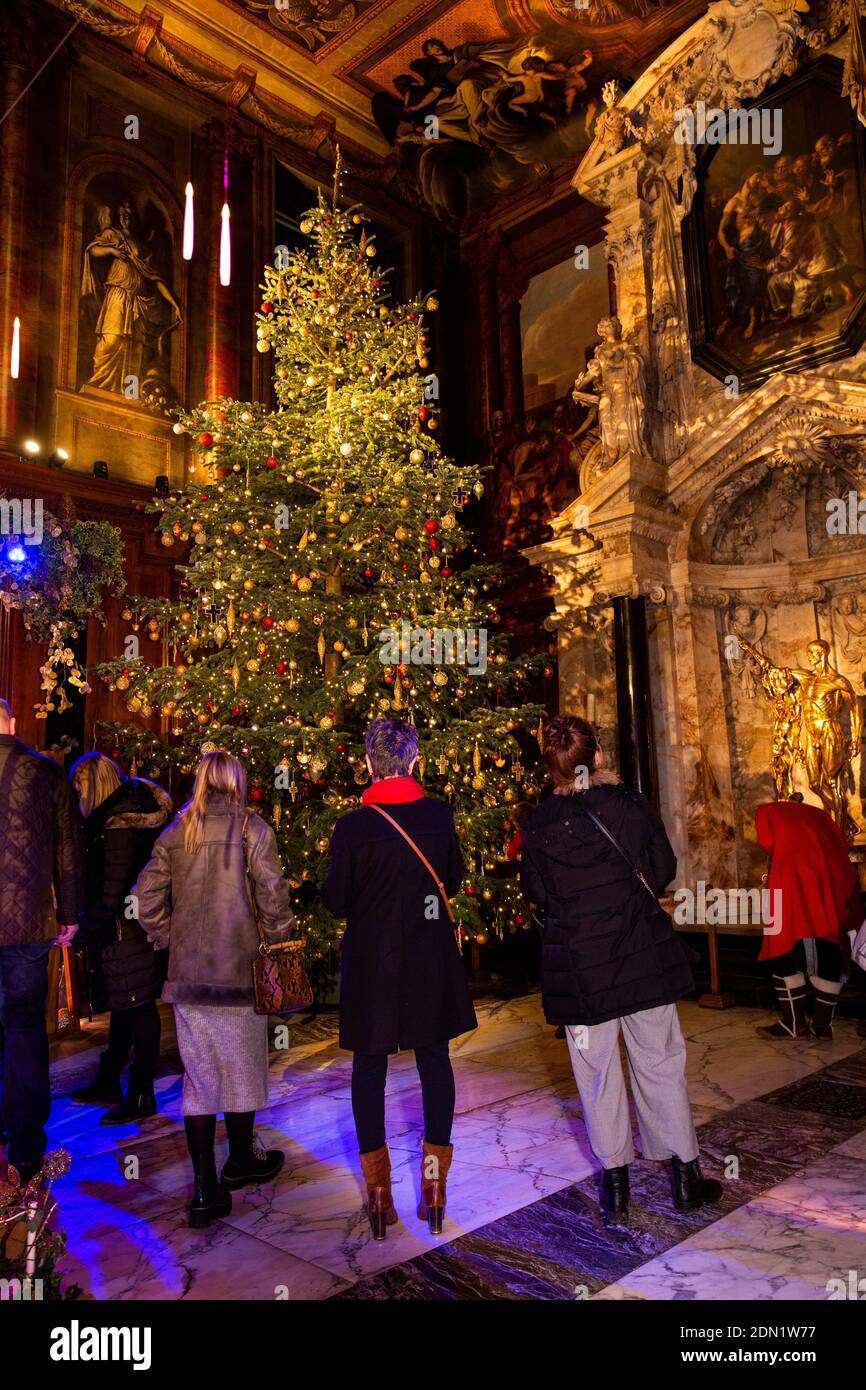 UK, England, Derbyshire, Edensor, Chatsworth House Chapel at Christmas, Lands Far Away, Spain, visitors at large Christmas tree beside Derbyshire Alab Stock Photo