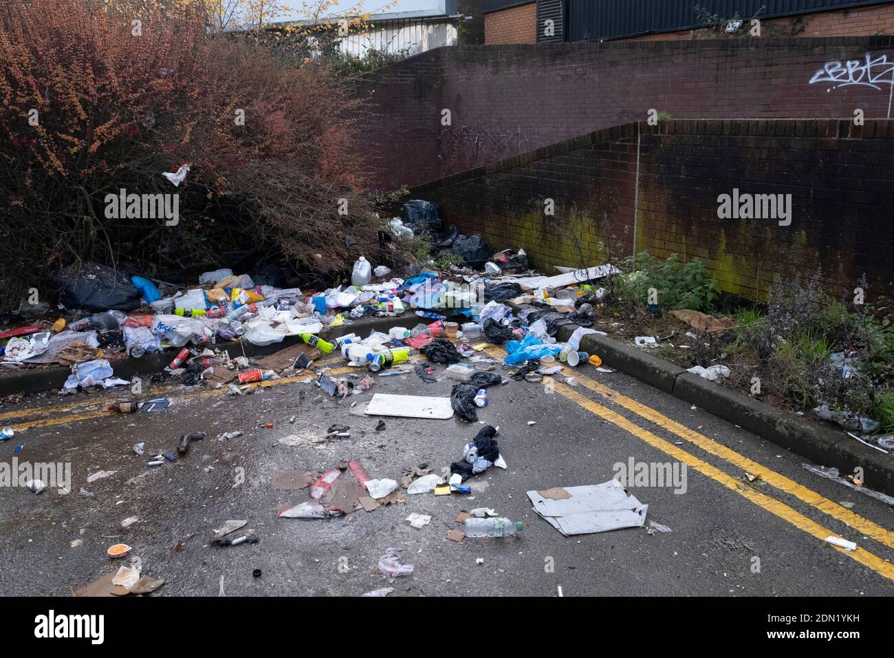 Fly tipped waste on the street in Highgate close to the city centre on 14th December 2020 in Birmingham, United Kingdom. Illegal dumping, also called fly dumping or fly tipping, is the dumping of waste illegally instead of using an authorised method such as kerbside collection or using an authorised rubbish dump. It is the illegal deposit of any waste onto land, including waste dumped or tipped on a site with no licence to accept waste. Stock Photo
