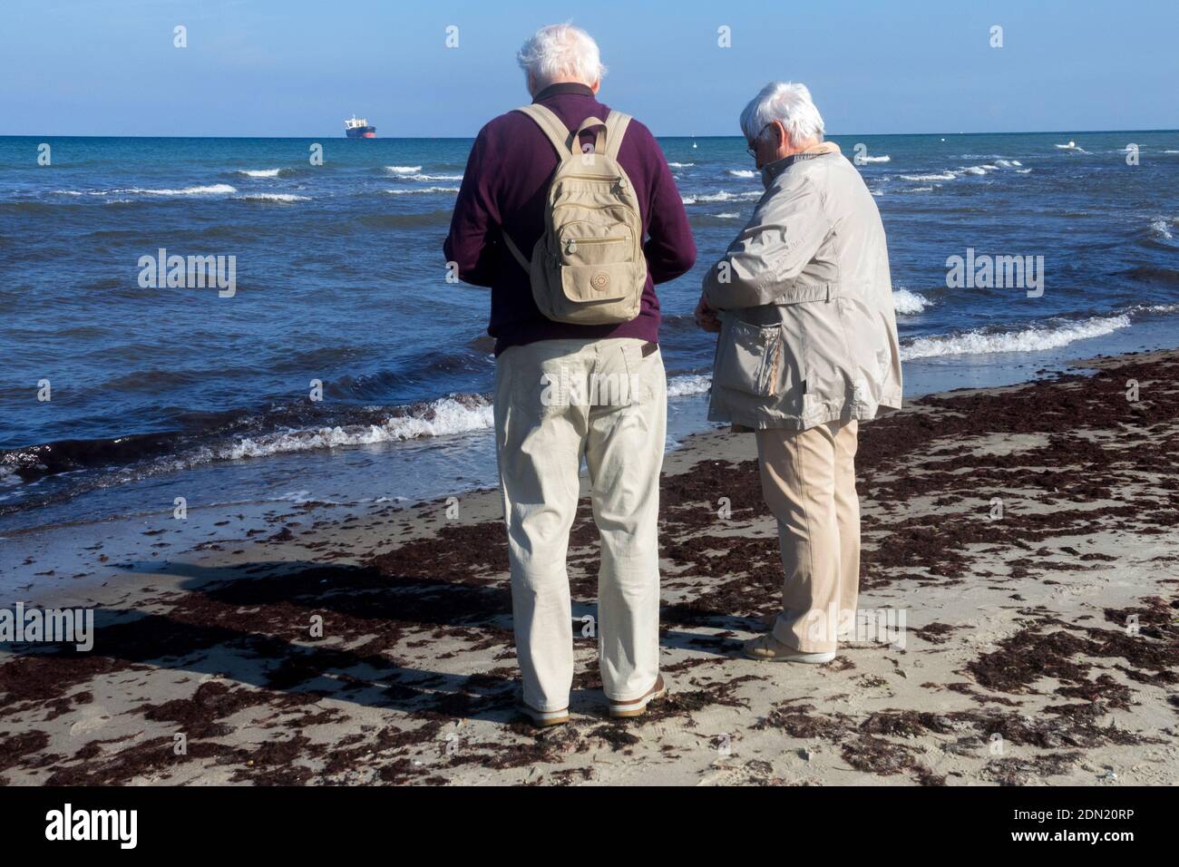 Senior couple walking on the beach Stock Photo - Alamy