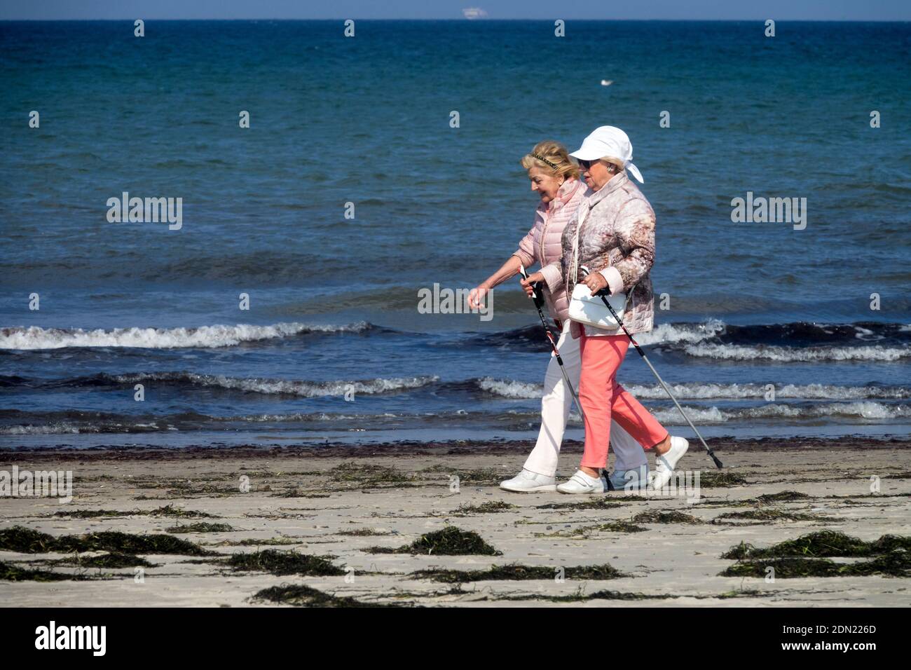 Two senior women walking on the beach, Baltic Sea shore Germany seniors old people elderly women walk Stock Photo