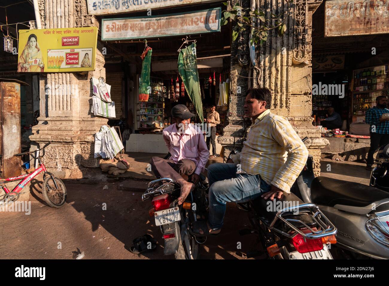 Jamnagar, Gujarat, India December 2018 Two Indian men having a conversation sitting on their