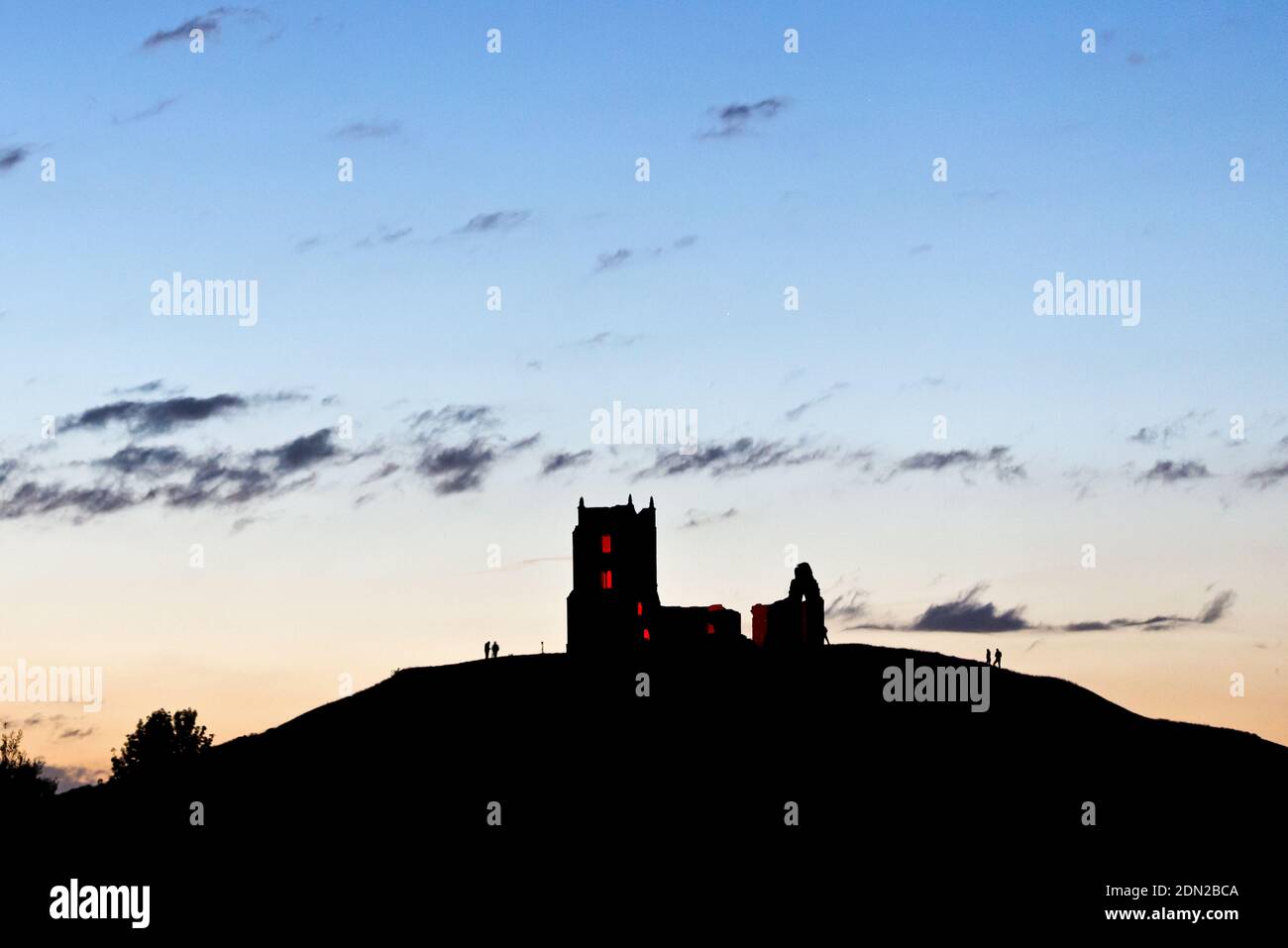 the sun setting behind Burrow Mump, Burrowbridge, Somerset, England, UK ...