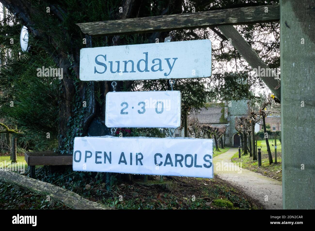 Sign outside a church advertising a Christmas open air carols event during the coronavirus covid-19 pandemic, December 2020 Stock Photo