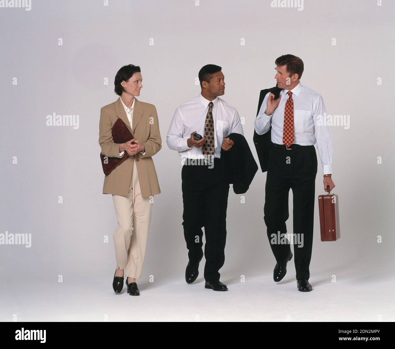 Full length view of three business executives walking. Stock Photo
