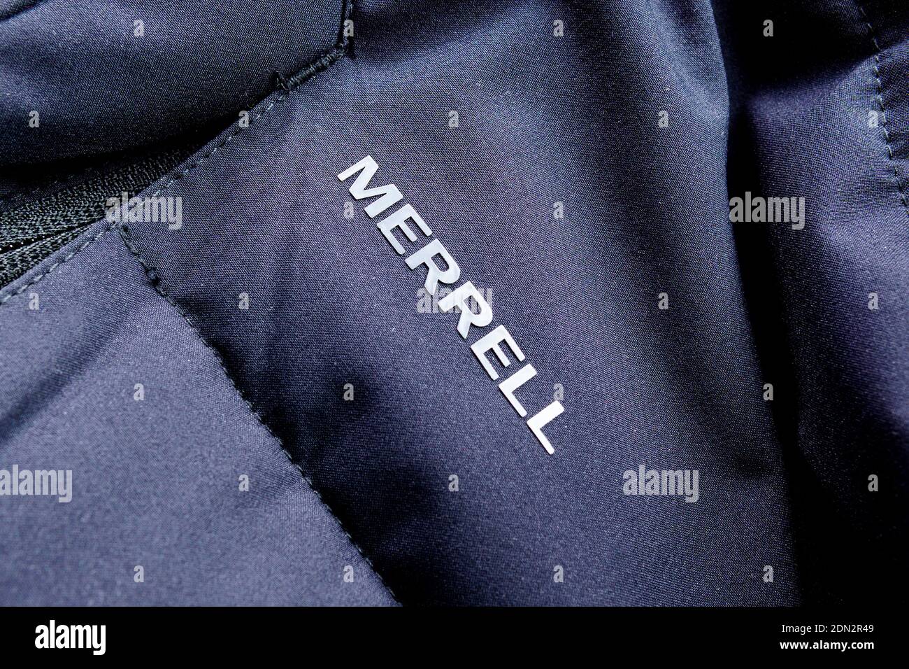 Tyumen, Russia-December 10, 2020: Merrell brand logo selective focus,  winter down jacket. Selective focus Stock Photo - Alamy