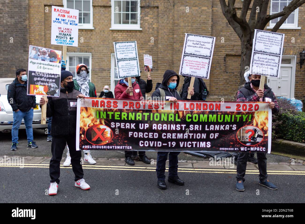 Protesters with placards during protest against forced cremation of COVID-19 victims in Sri Lanka, Embassy of Sri Lanka, London, 12 December 2020 Stock Photo