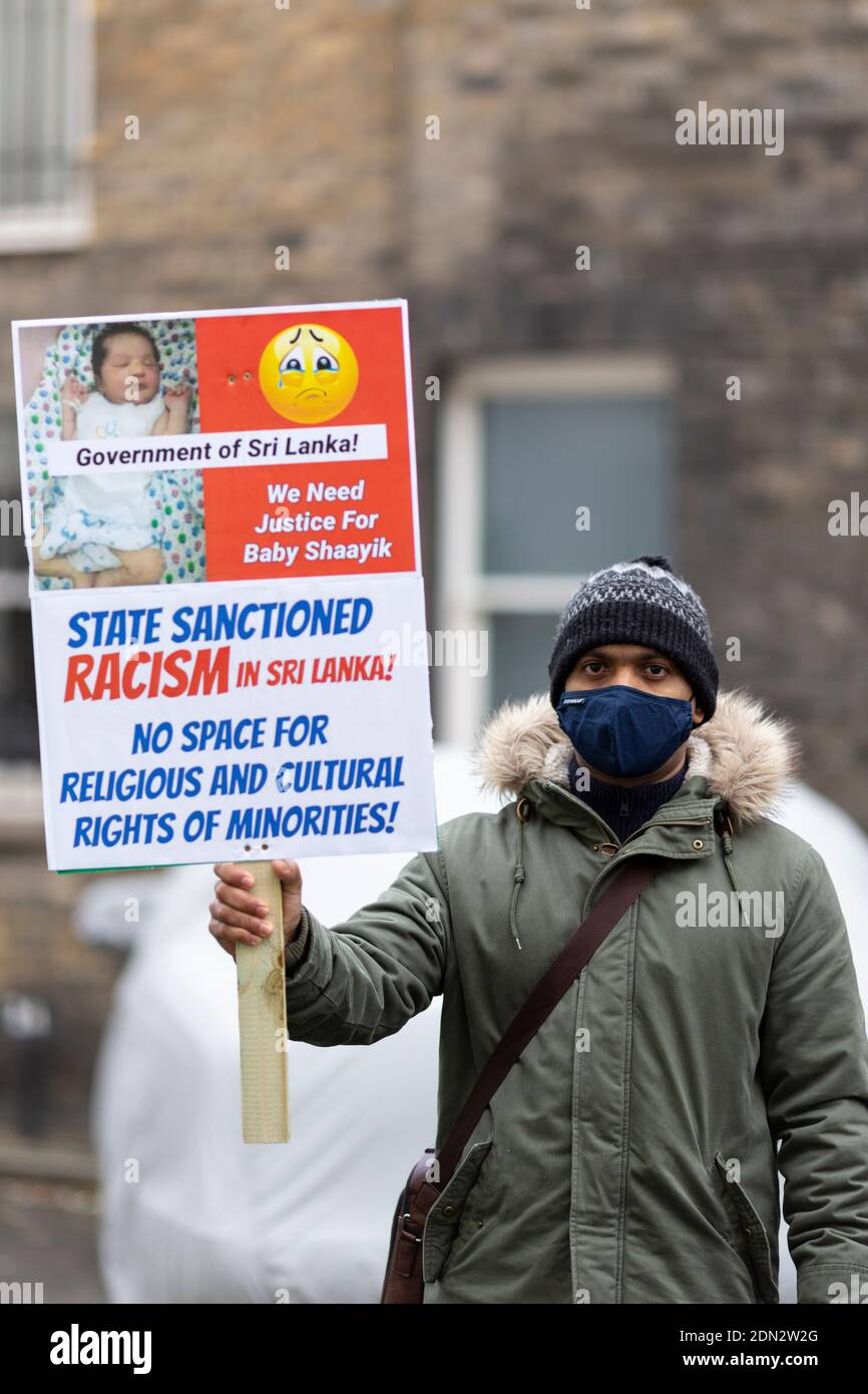 Protester with placard during protest against forced cremation of COVID-19 victims in Sri Lanka, Embassy of Sri Lanka, London, 12 December 2020 Stock Photo