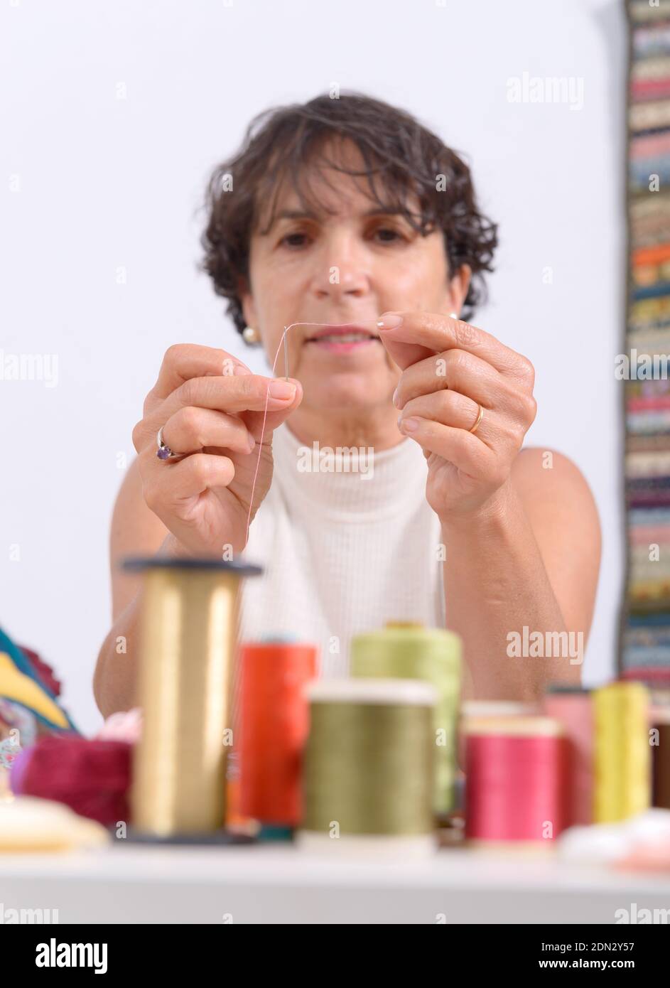 Woman Holding Sewing Needle And Thread On Table Stock Photo Alamy