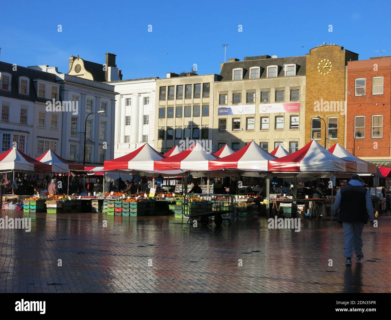 With its origins in medieval times, Northampton's Market Square continues to this day with colourful awnings over the stalls of fruit & veg. Stock Photo