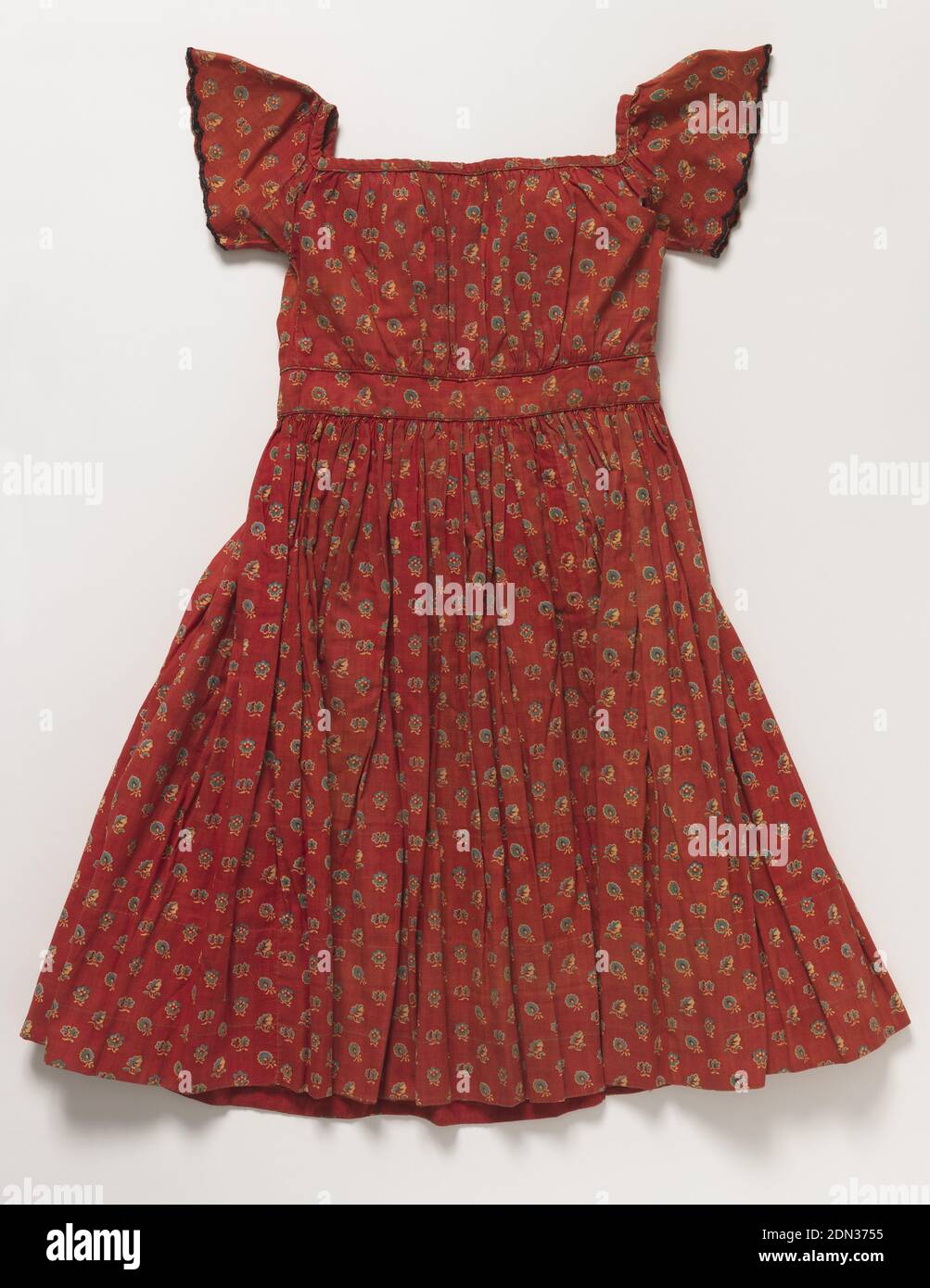 Dress, Medium: Printed cotton Technique: Printed plain weave, Child's short-sleeved dress in a red printed floral cotton., USA, 1864–65, printed, dyed & painted textiles, Dress Stock Photo