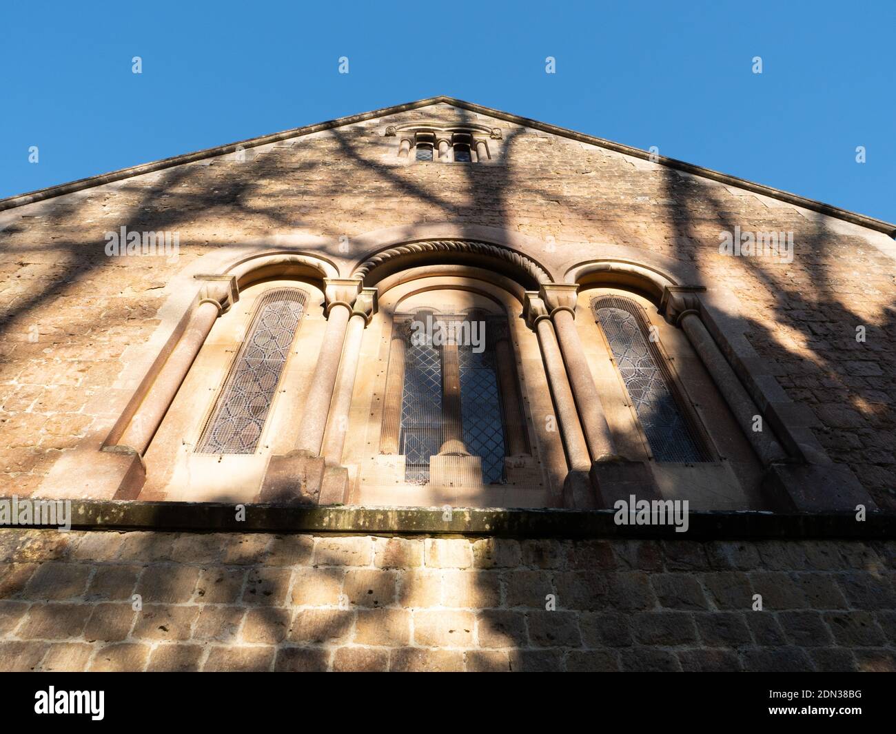 Round arched windows on south side of apse on Holy Trinity Church, Dilton Marsh, Wiltshire, England, UK. Stock Photo