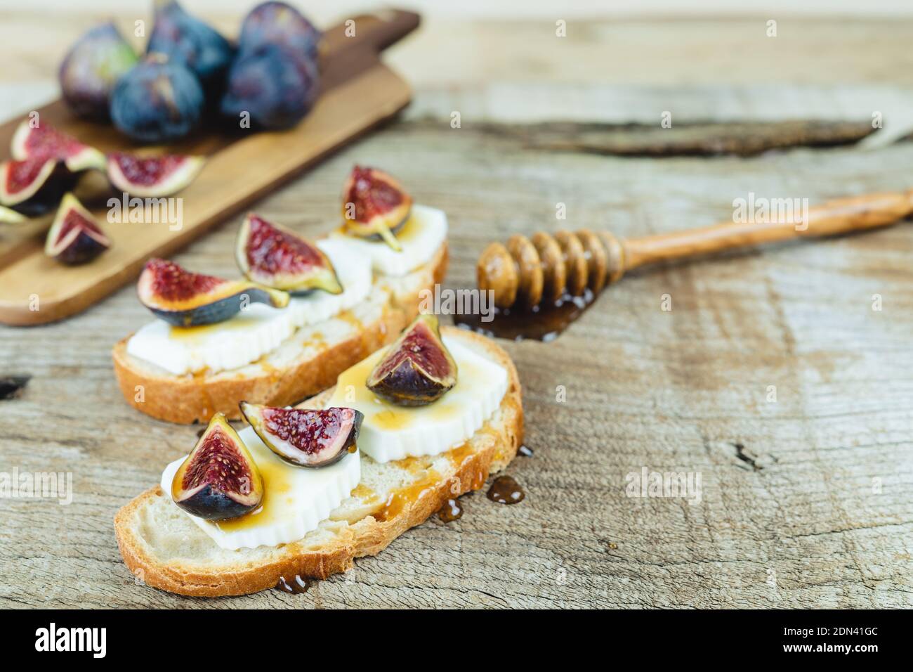 Figs with fresh cheese on toast Copy space. Stock Photo