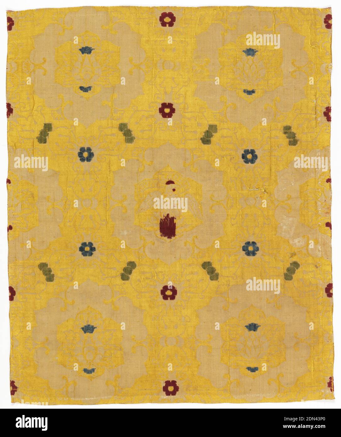 Textile, Medium: silk Technique: supplementary warp pile (velvet), voided, with 1/2 twill, Heavy symmetrical leafy ogee-type grid framing blossoms in 6-lobed medallions in white on a yellow background. The medallion in the center of the fabric holds a phoenix rising from a pyre bearing a scroll 'NORS VIVE' in mirror imaged letters. Pattern embellished with red, green, and blue details in uncut pile loops. The white was cut-pile velvet, now mostly worn off; the yellow 1/2 twill., Italy, ca. 1500, woven textiles, Textile Stock Photo