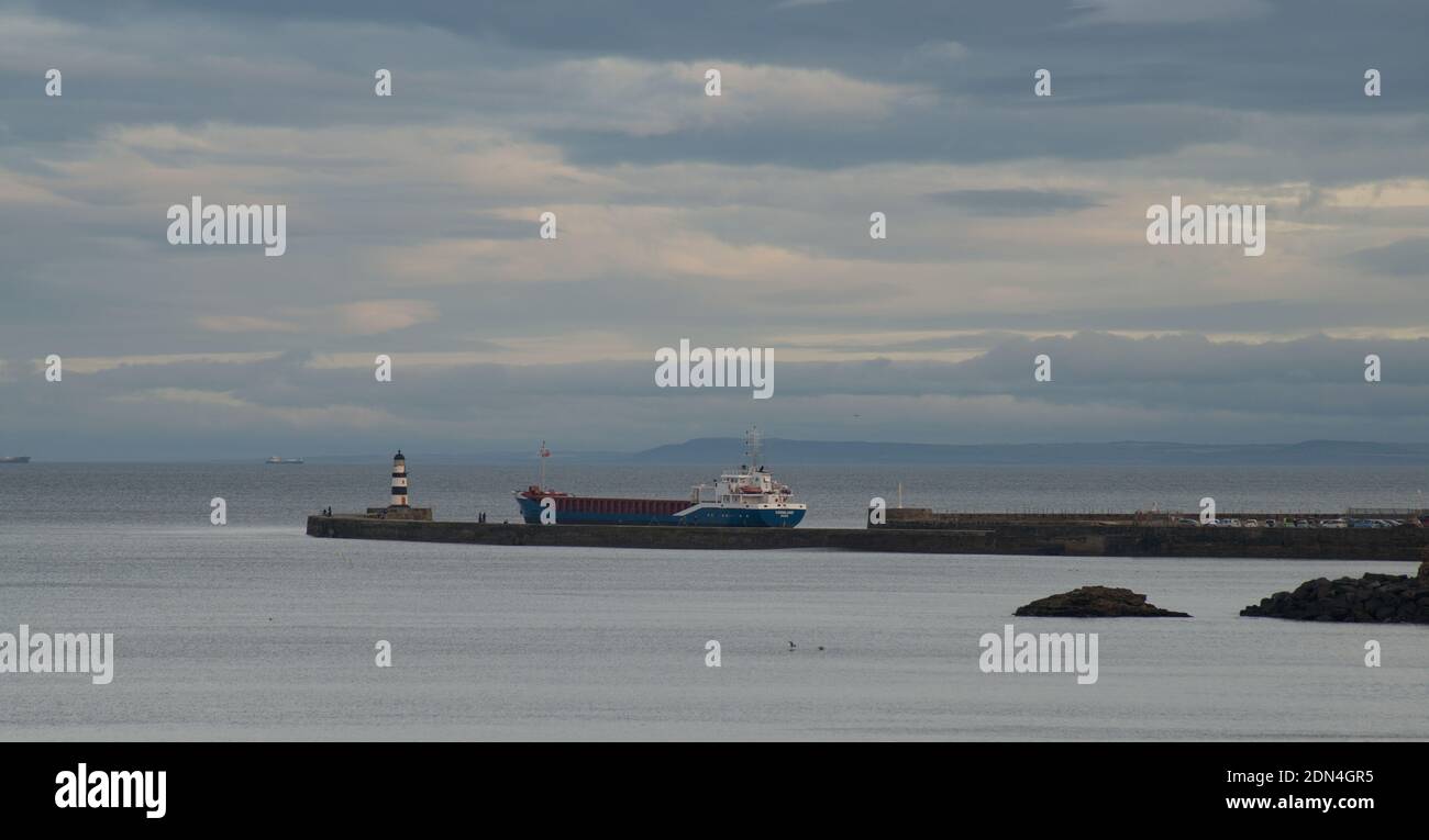 Merchant vessel Varmland leaves the port of Seaham on the North East coast of England Stock Photo