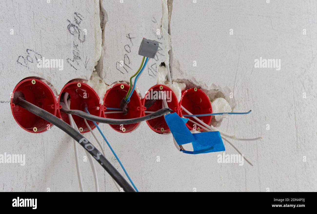 Installation of electrical wiring, red plastic boxes and electrical