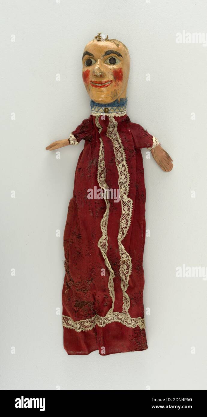 Puppet, Painted wood, cotton, other materials, Wide-eyed face with red cheeks. Figure dressed in red and white lace, blue fringe at the neck. Remains of crepe hair., England, late 19th century, theater, Decorative Arts, Puppet Stock Photo
