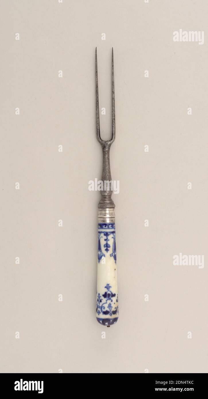 Fork with Blue Pattern on Porcelain Handle, Saint-Cloud Porcelain Manufactory, French, active by 1693 - 1766, porcelain, vitreous enamel, steel, silver, Two long curved tines, rounded shoulders, baluster-shaped neck. Silver ferrule with horizontal bands. Tapering white porcelain handle with dark- blue floral and scrolled decoration. Button cap missing., France, ca. 1730, cutlery, Decorative Arts, fork, fork Stock Photo
