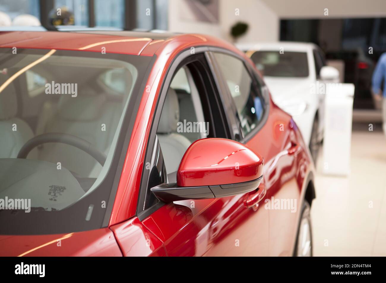 Cropped shot of a new shiny red automobile on sale at car dealership. Auto sales concept Stock Photo