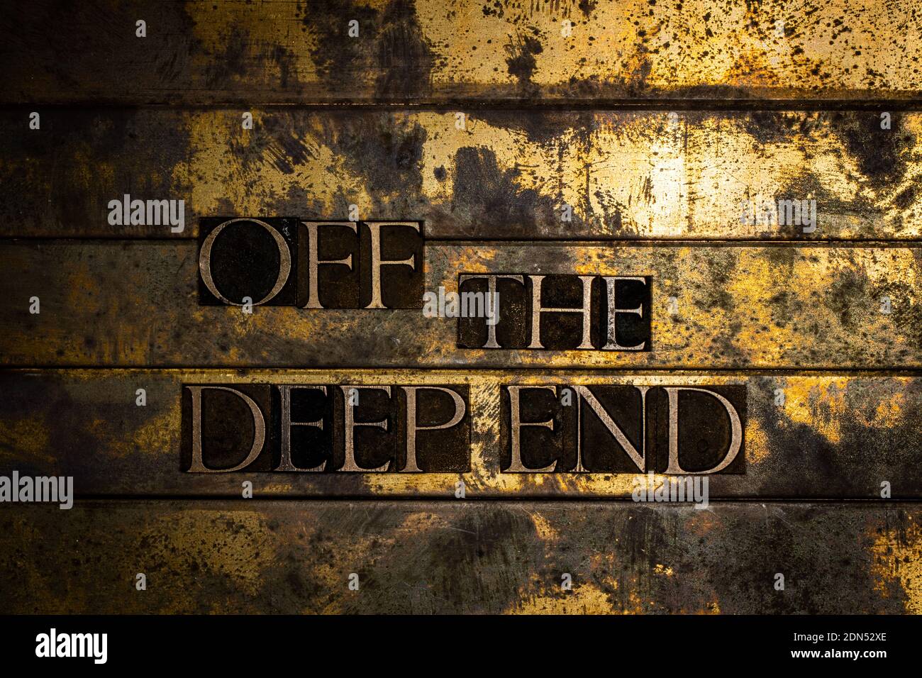 Off The Deep End text on vintage textured bronze grunge copper and gold background Stock Photo