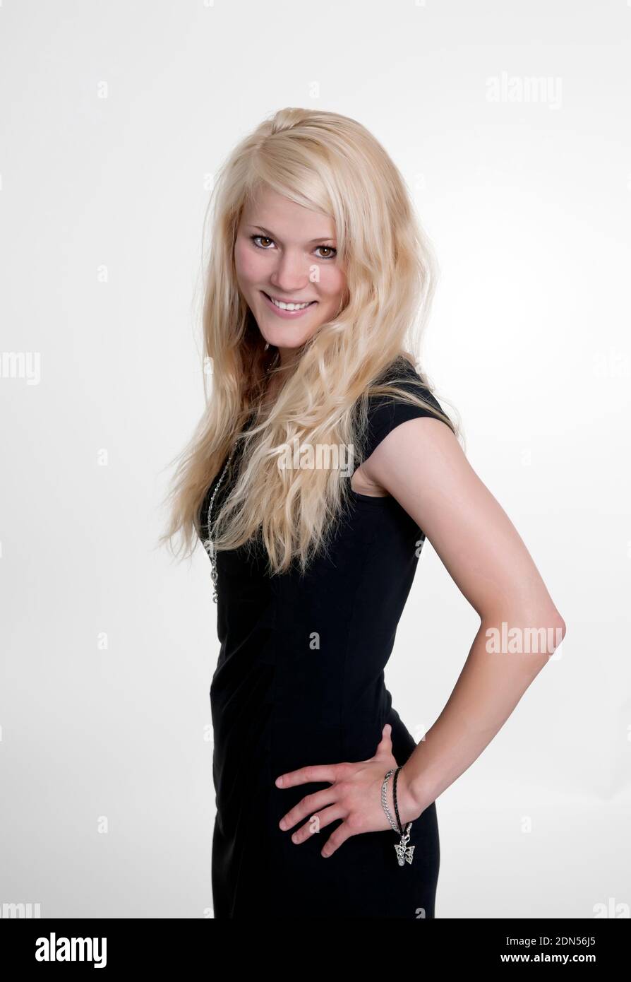pretty young woman in  black dress smiling Stock Photo