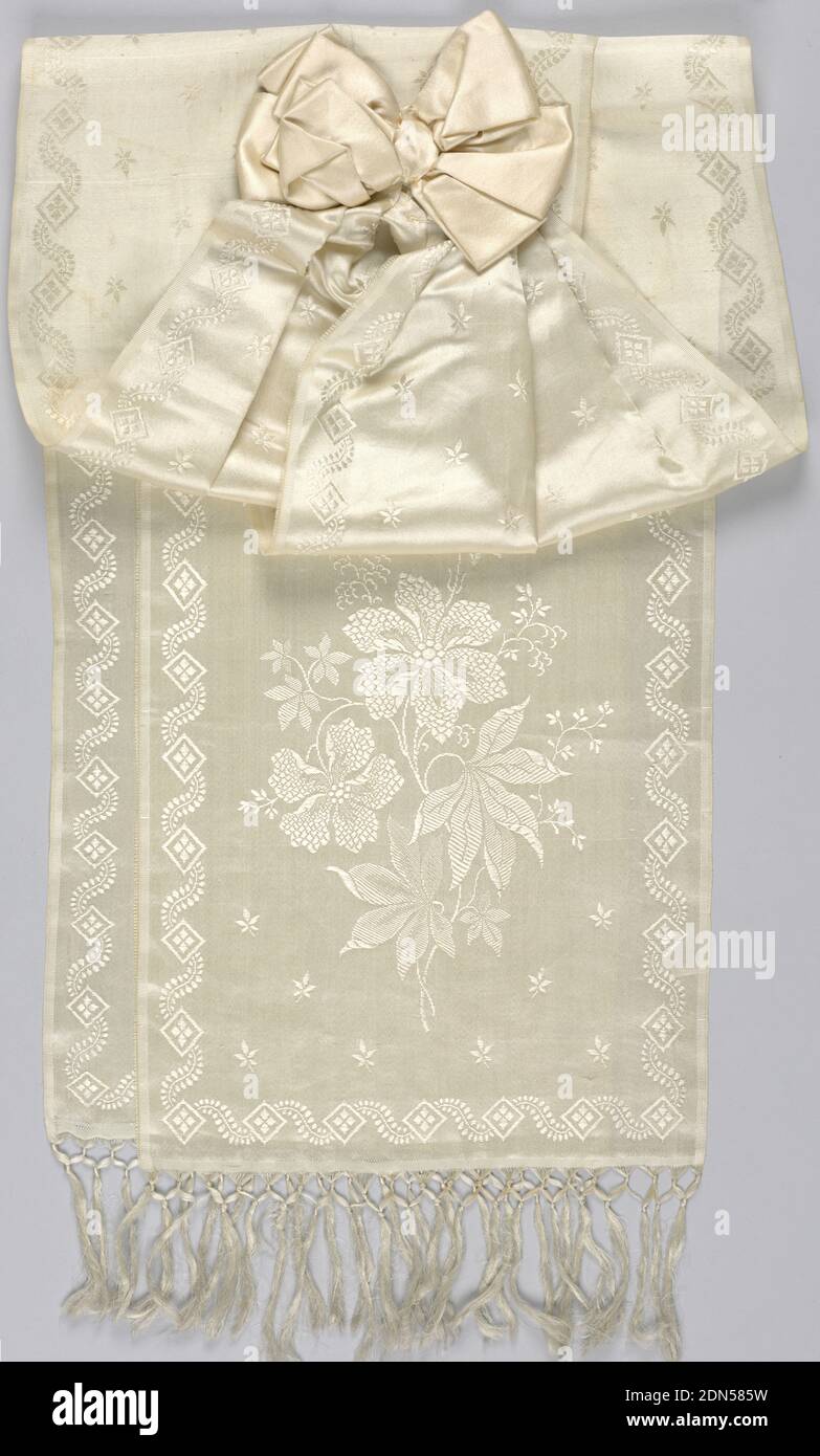 Bow with ribbons, Medium: silk (?) Technique: satin weave, White satin bow with two long pieces of broad figured white satin ribbon with fringed ends. Possibly part of a dress trimming., USA, ca. 1875, woven textiles, Bow with ribbons Stock Photo