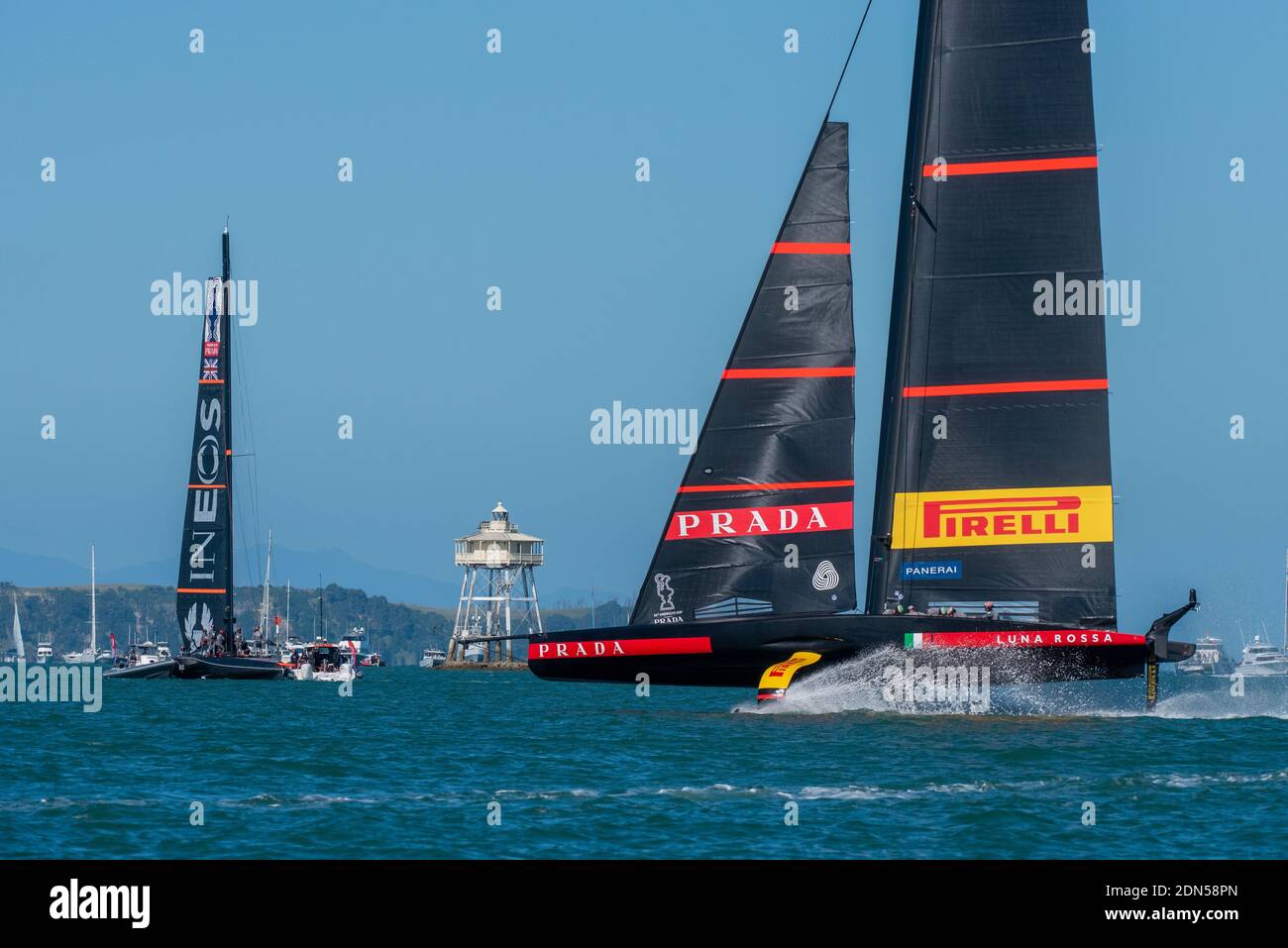 Luna Rossa Prada Pirelli Team foil past the broken down INEOS Team UK boat Britannia in race three. PRADA America's Cup World Series Auckland Race Day One. 17/12/2020 Stock Photo