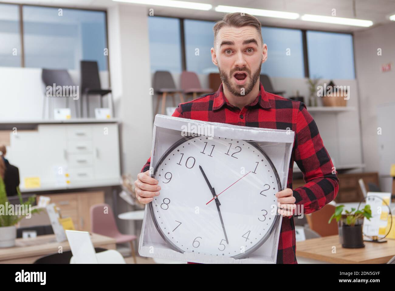 Handsome Bearded Man Looking Overwhelmed Holding Big Wall Clock At The Furniture Store Copy Space Attractive Man Looking Shocked Holding Big Clock Stock Photo Alamy