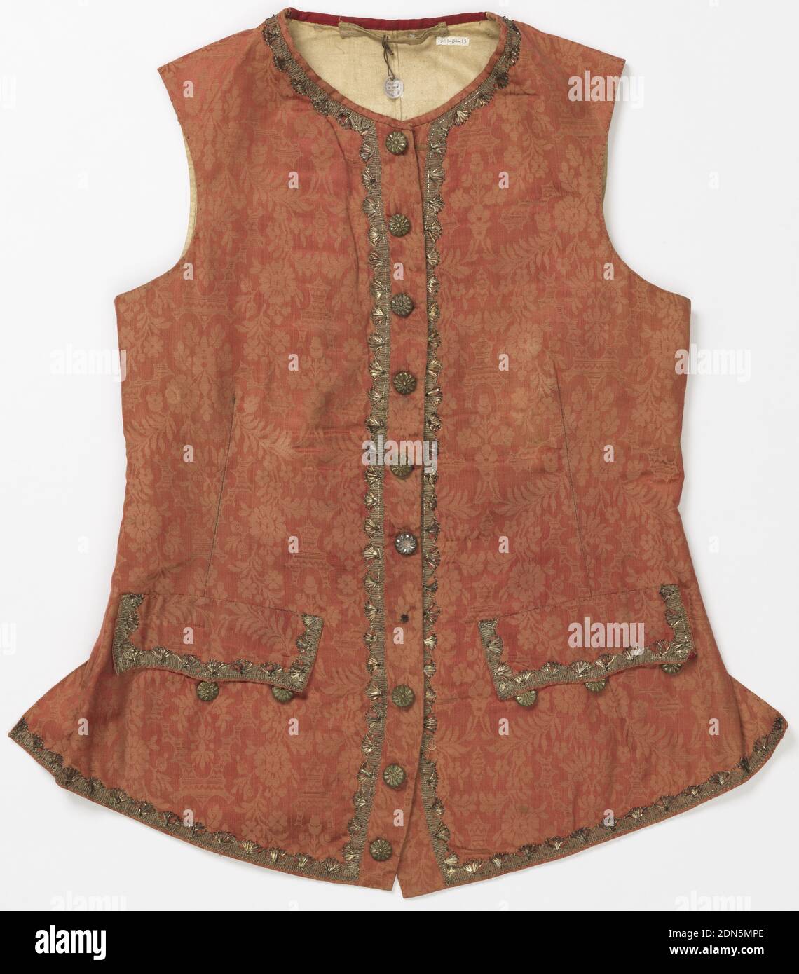 Waistcoat, Medium: silk, metallic thread Technique: woven, bobbin lace, Collarless and sleeveless waistcoat in an orange-red patterned silk with metallic bobbin lace appliqué and metal buttons. Slightly pointed pocket flaps. Possibly made for fancy dress., 19th century, costume & accessories, Waistcoat Stock Photo