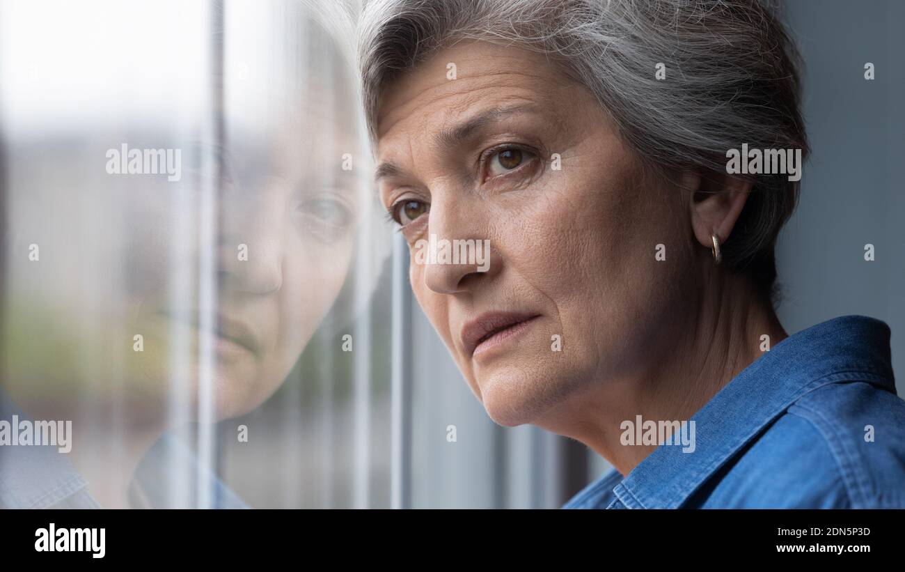 Frustrated middle aged 60s woman looking in distance. Stock Photo