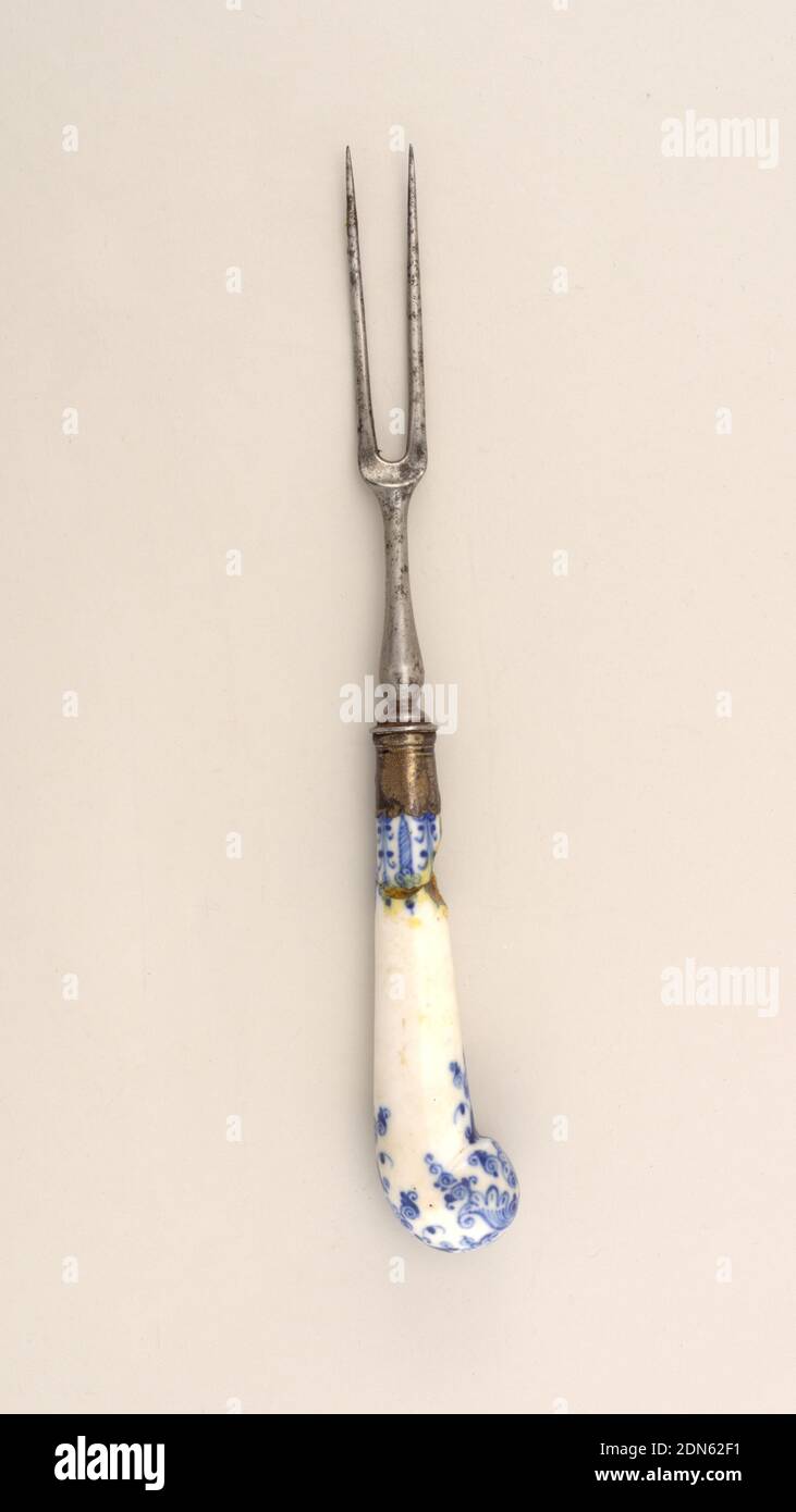 Fork with Blue Pattern, Saint-Cloud Porcelain Manufactory, French, active by 1693 - 1766, porcelain, vitreous enamel, steel, silver, Two long curved tines, rounded shoulders and a baluster-shaped neck. Silver ferrule has horizontal bands and a scalloped edge. Pistol-shaped white porcelain handle with dark blue floral and scrolled decoration., France, ca. 1744, cutlery, Decorative Arts, fork, fork Stock Photo