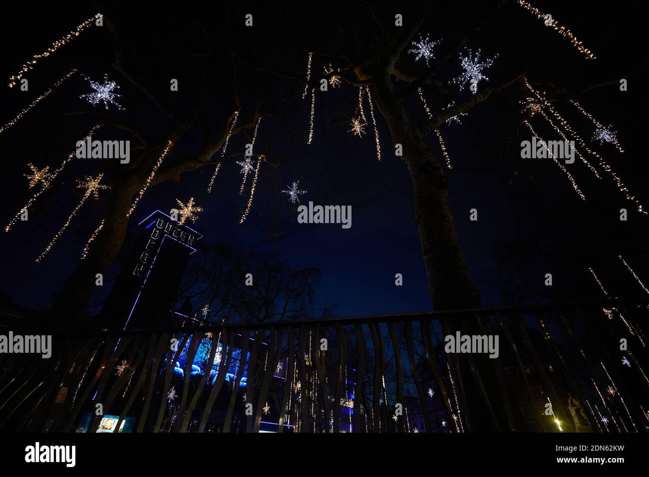 London, UK. - 15 Dec 2020: Festive lights hanging from trees adorn Leicester Square for Christmas 2020. Stock Photo