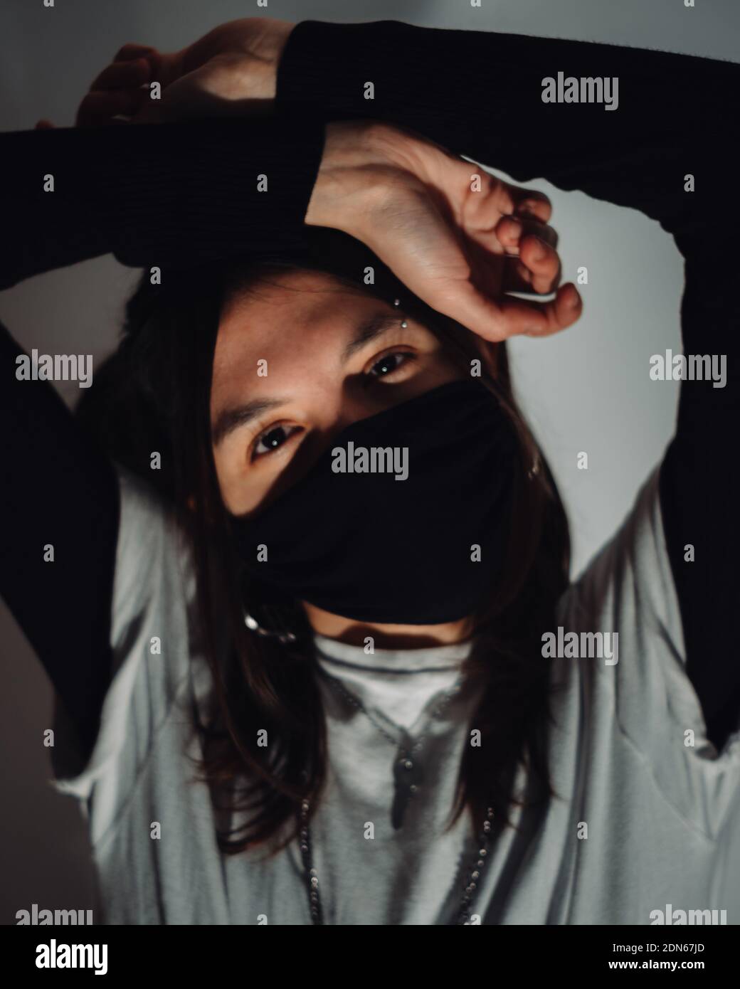 A portrait of a young girl in a black medical mask - new normal Stock ...
