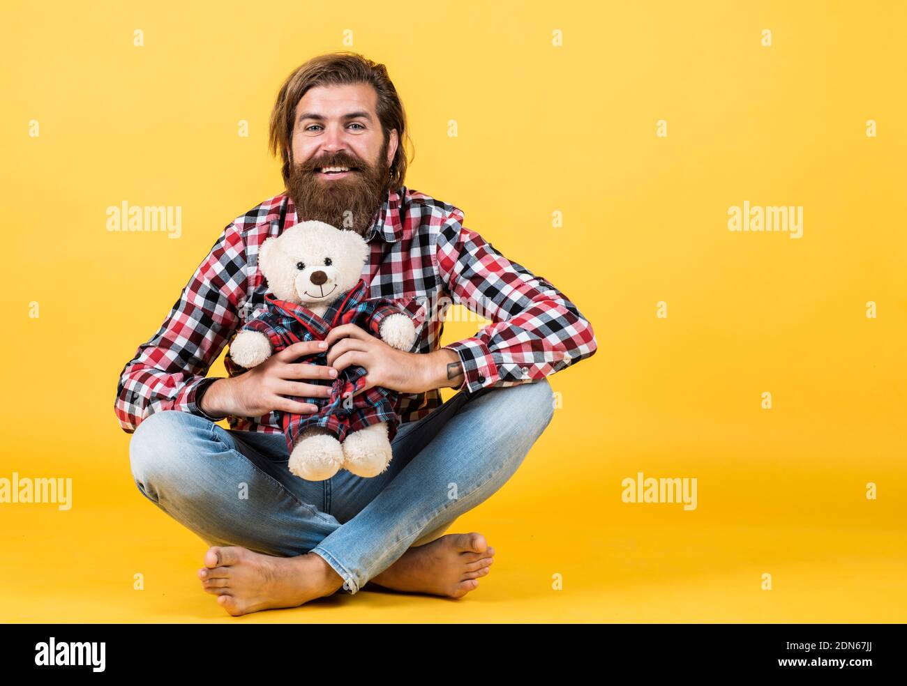 Gifts and holidays concept. This is for you. hipster like animal toy. Birthday holiday party celebration. feel happiness. Man with beard hold cute toy bear. Man holds teddy bear. copy space Stock Photo