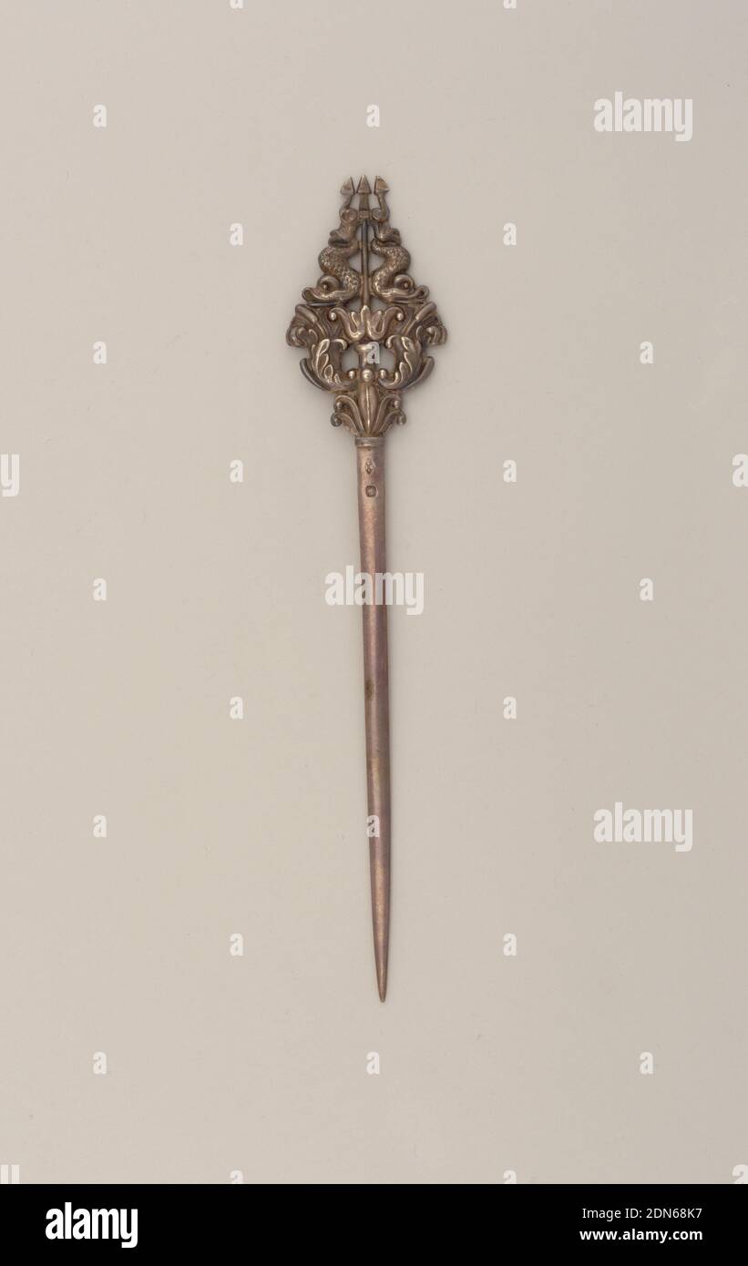 Skewer, Silver, Tapering pointing blade or pin; cast terminal embossed with cat-tail topped acanthus fronds below a pair of opposing dolphins centering a trident., France, late 19th century, cutlery, Decorative Arts, Skewer Stock Photo
