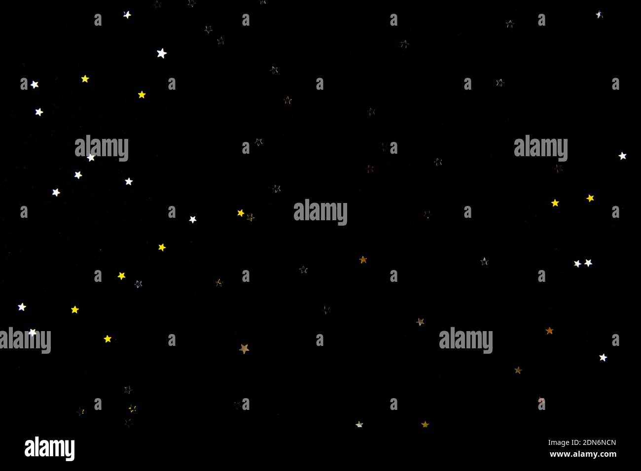 black background with yellow and gray glitter stars. Copyspace Stock