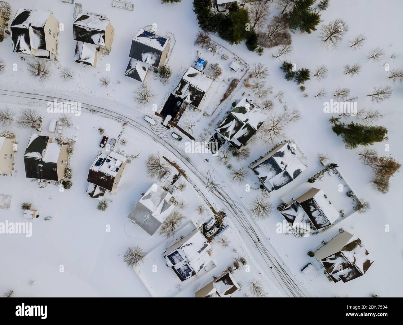 Aerial view over private houses in wintertime on of snow covered ...