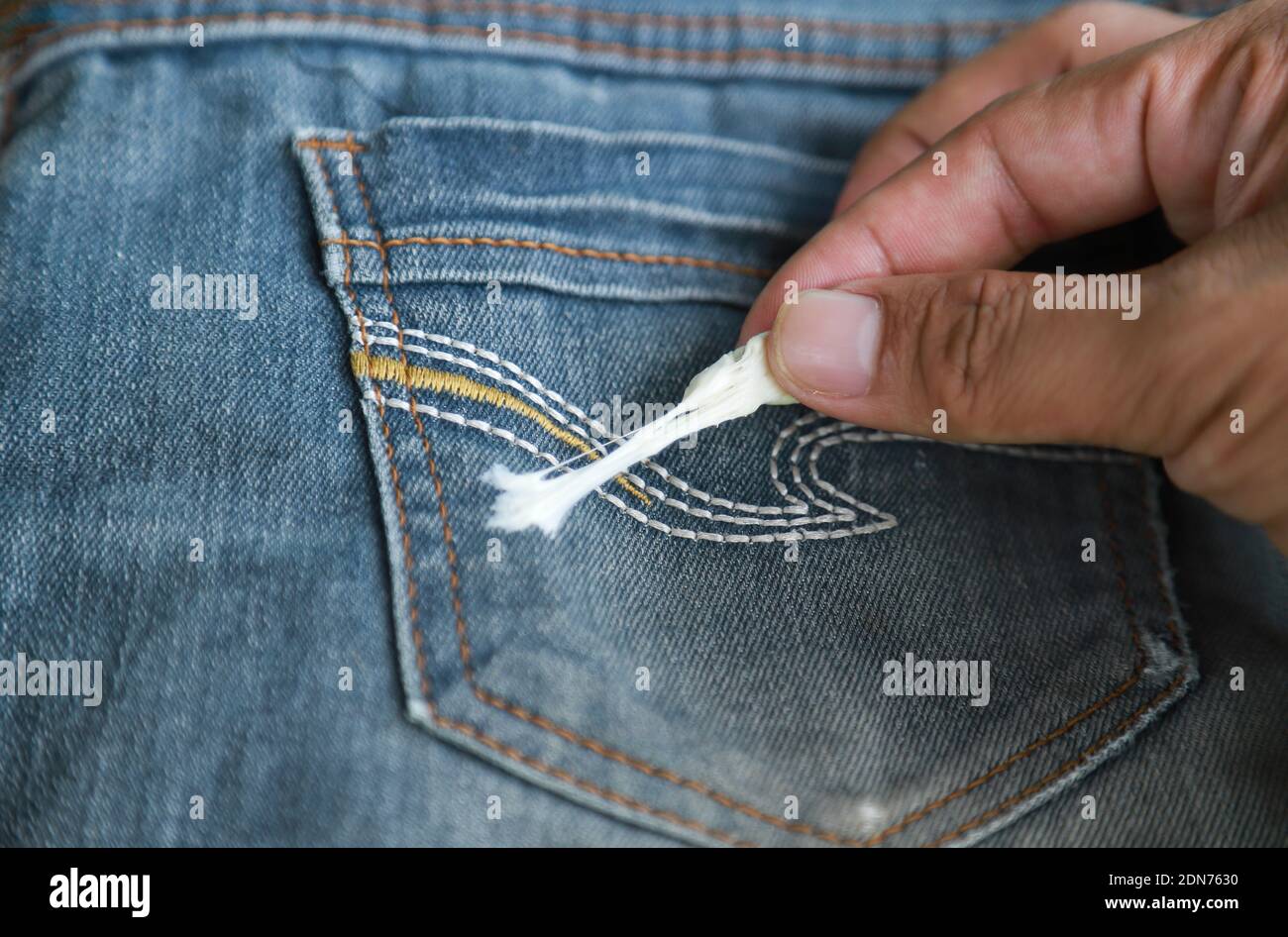 Cropped Hand Removing Chewing Gum Stuck On Jeans Stock Photo - Alamy