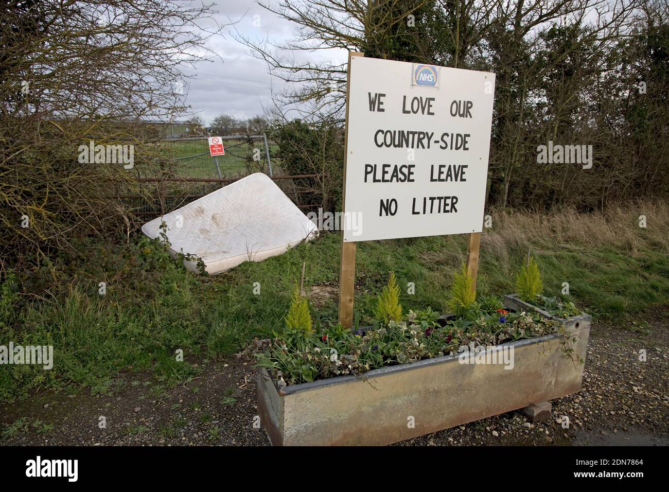 Old mattress dumped by two no litter signs in rural Warwickshire UK Stock Photo