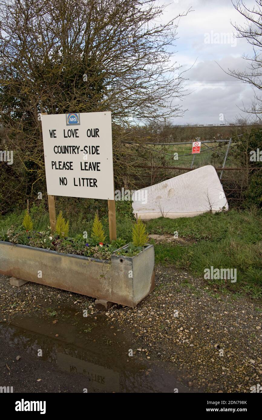 Old mattress dumped by two no litter signs in rural Warwickshire UK Stock Photo