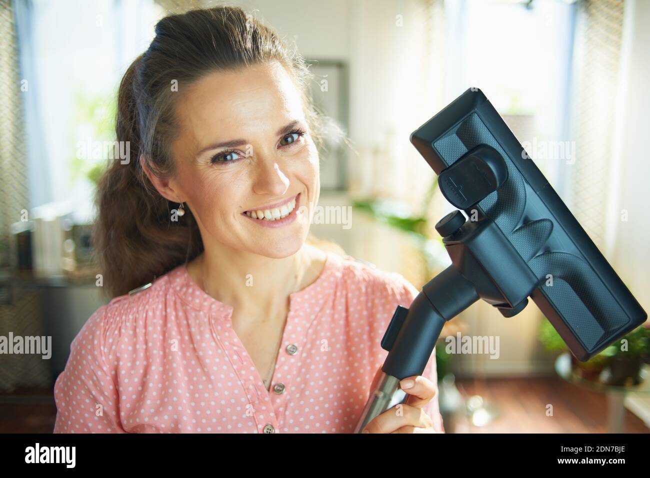 Portrait of happy 40 years old woman in blouse and white pants with